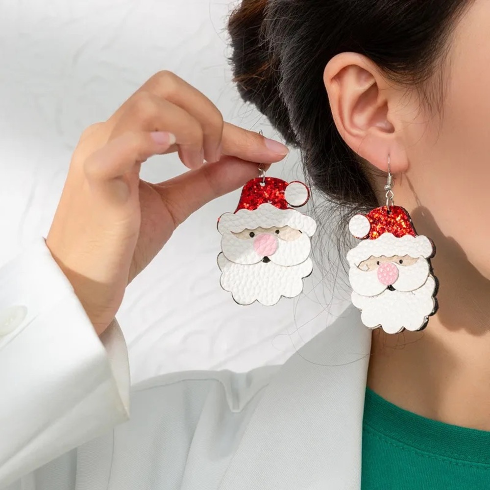NWT pair of fun and festive Santa Claus vegan leather dangling earrings.